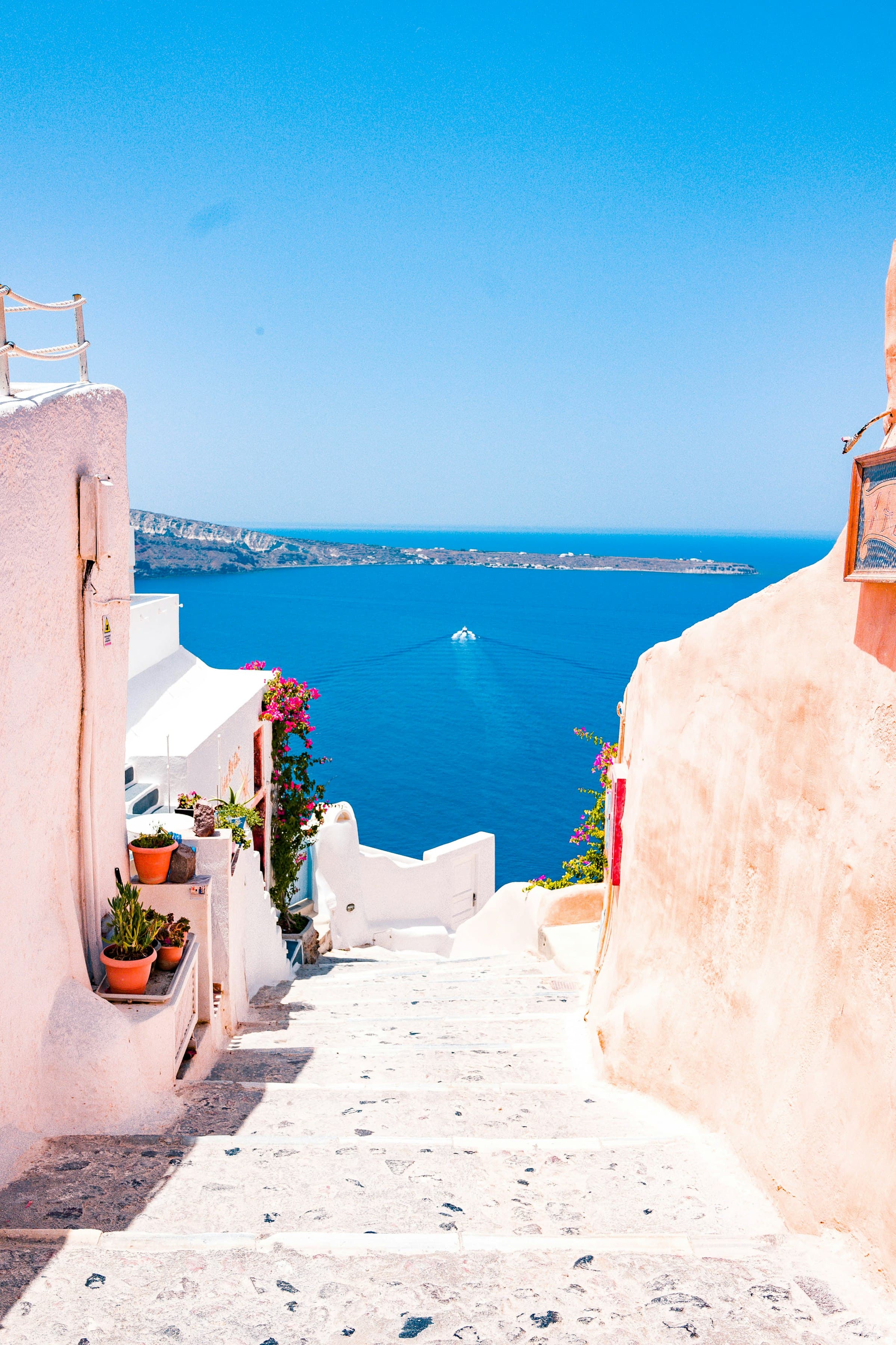 Whitewashed seaside hotel steps overlooking the Mediterranean